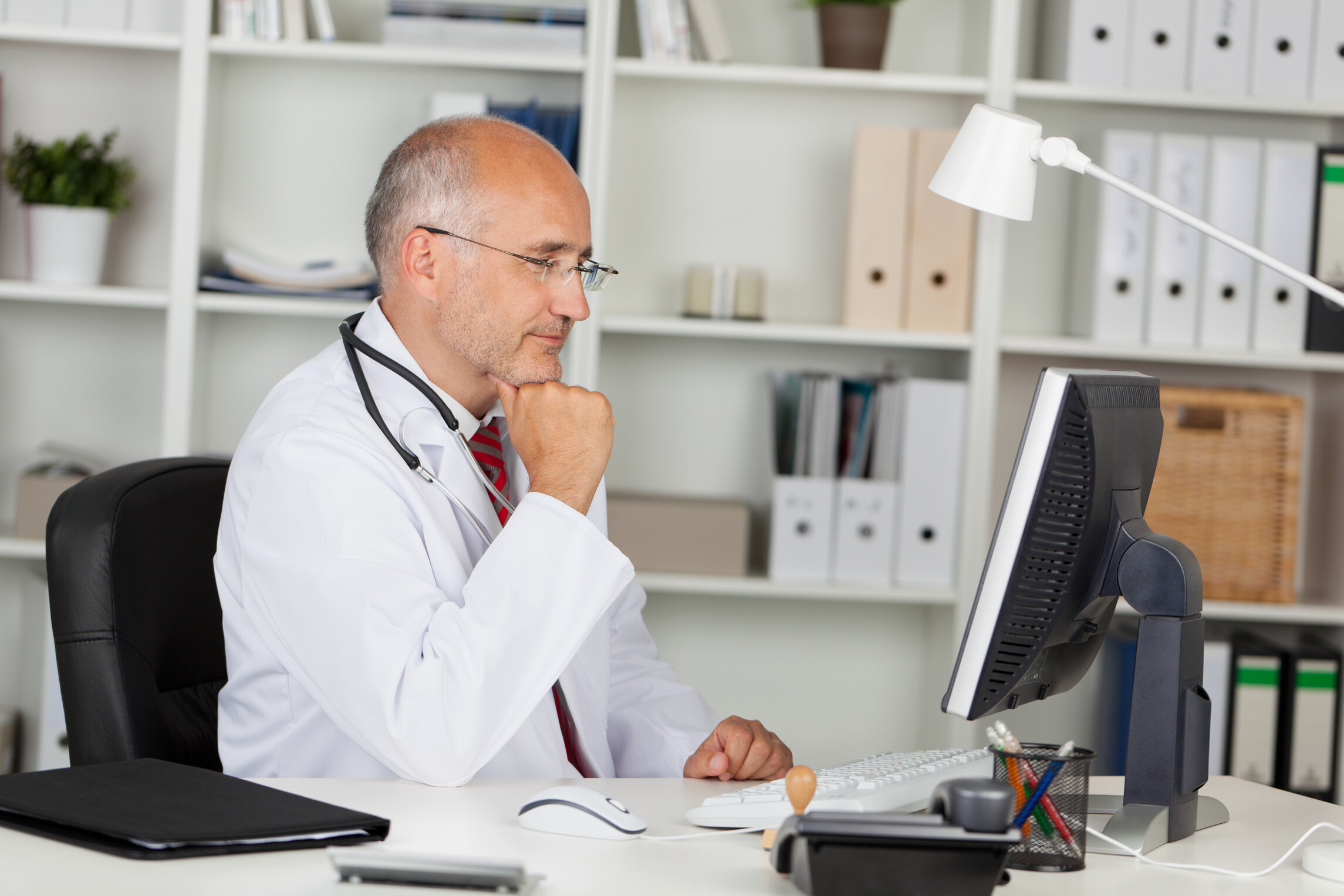Doctor studying a computer screen